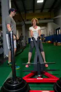 Personal trainer in Harrisburg PA working with client on sled