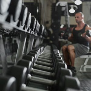 Man lifting free weights at Platinum Fitness